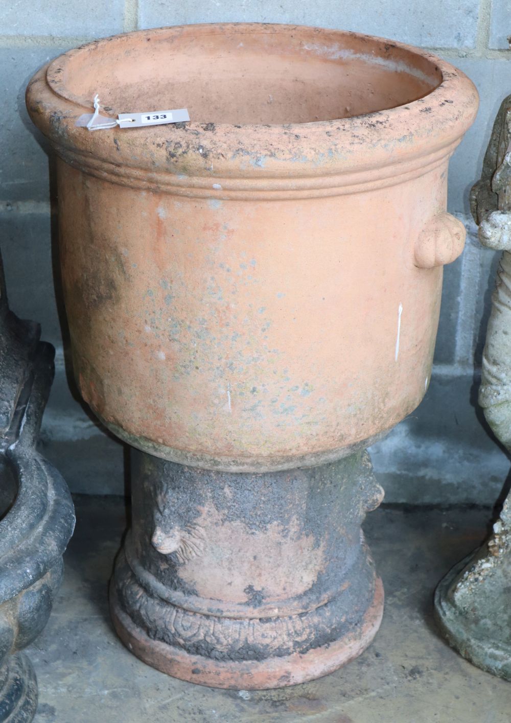 A terracotta garden urn on pedestal, W.50cm, H.73cm